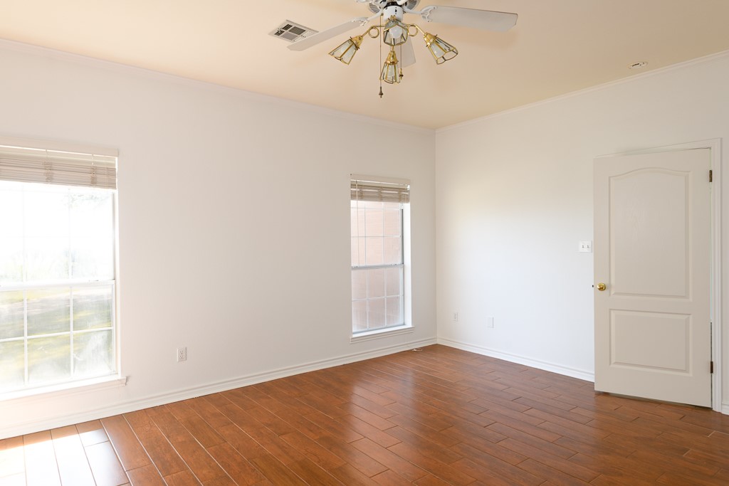 4488 Blue Ridge Drive Belton, TX 76513 - Photo 20 of 35 an empty room with wooden floor and windows