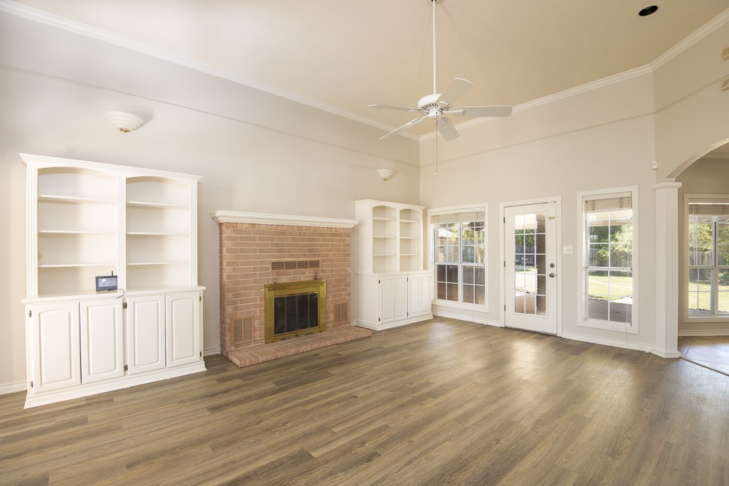 4488 Blue Ridge Drive Belton, TX 76513 - Photo 6 of 35 an empty room with wooden floor fireplace and windows
