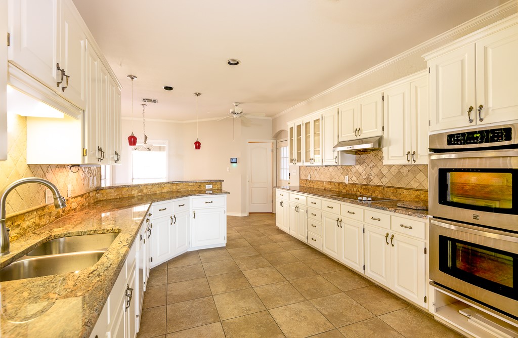 4488 Blue Ridge Drive Belton, TX 76513 - Photo 9 of 35 a large white kitchen with stainless steel appliances granite countertop a stove and a sink