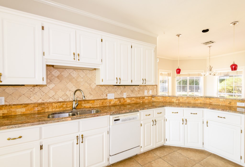 4488 Blue Ridge Drive Belton, TX 76513 - Photo 10 of 35 a kitchen with granite countertop white cabinets white appliances and a sink
