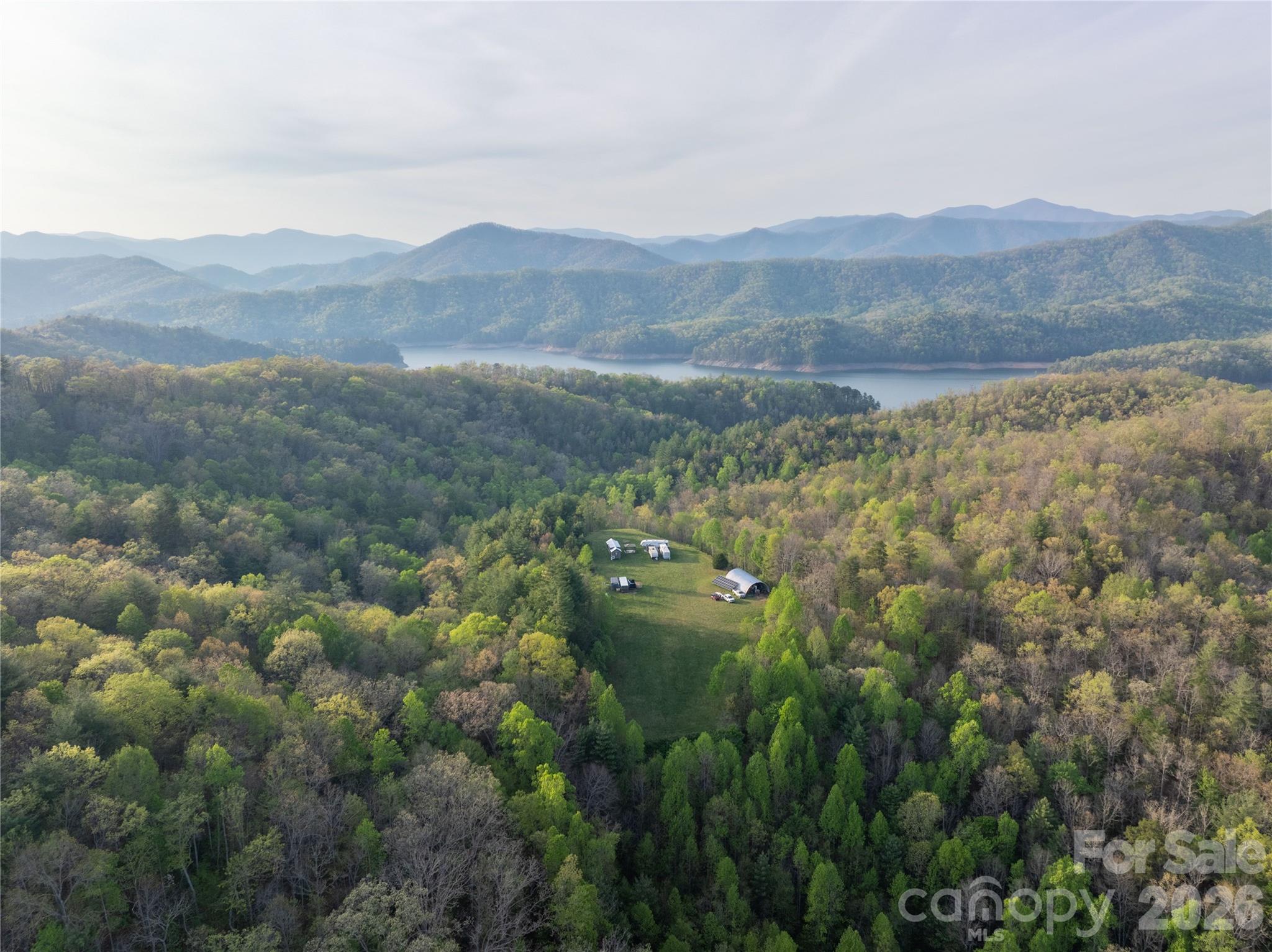 8888 Yellow Branch Road Robbinsville, NC 28771 - Photo 2 of 28 a view of a lush green hillside and houses