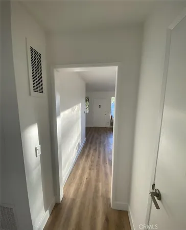 a view of a room with wooden floor