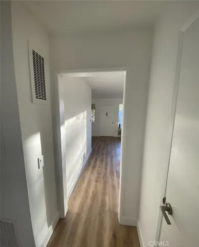 a view of a room with wooden floor