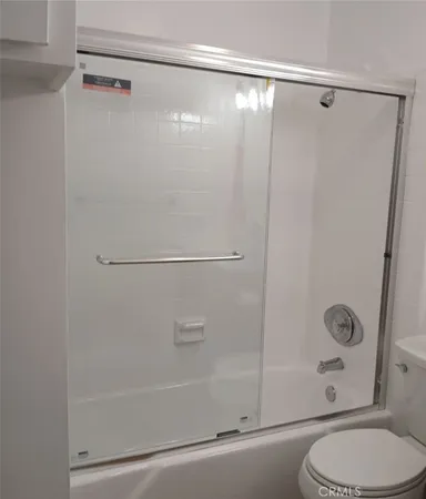 a bathroom with a shower and a toilet