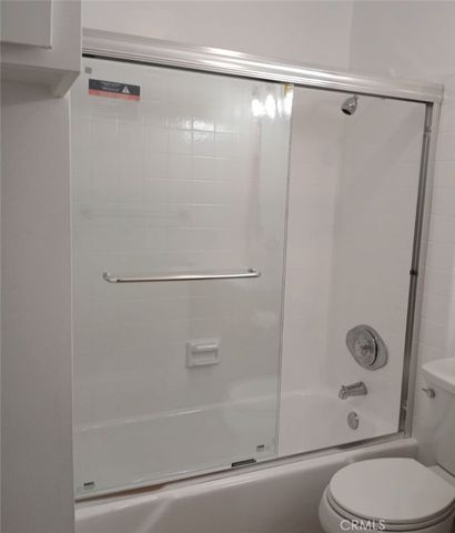 a bathroom with a shower and a toilet