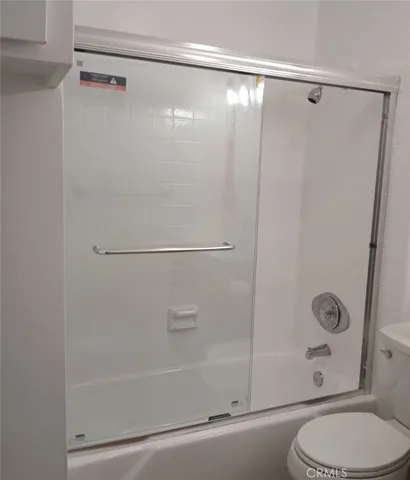 a bathroom with a shower and a toilet
