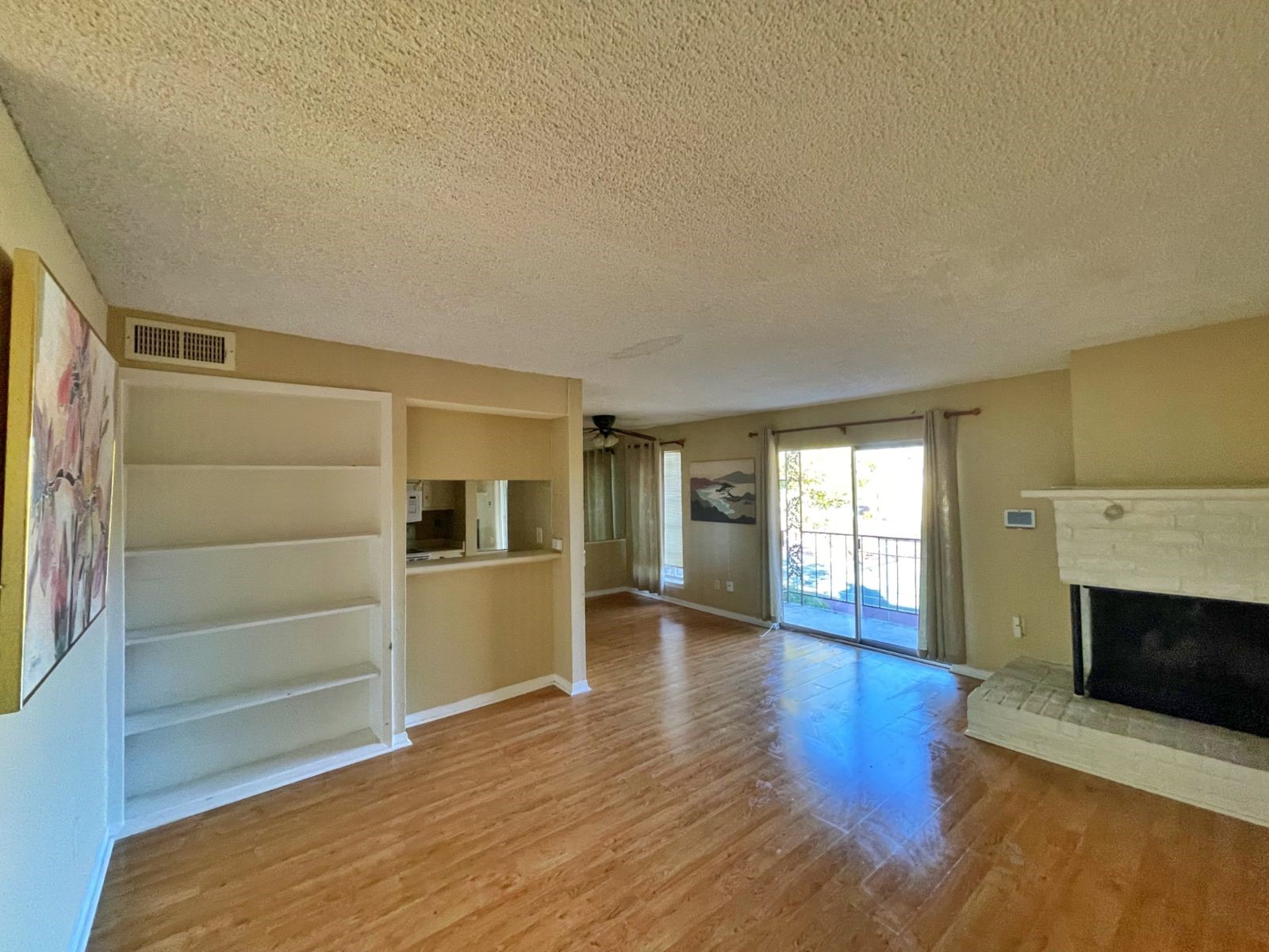 2800 Jeanetta Street, Unit 1110 Houston, TX 77063 - Photo 4 of 6 a view of empty room with wooden floor and fireplace