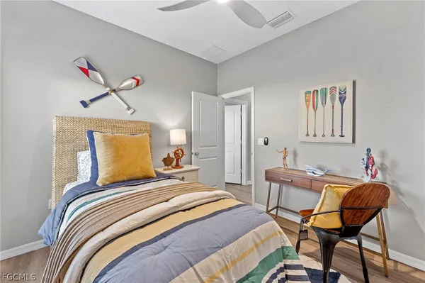 a bedroom with bed and wooden floor