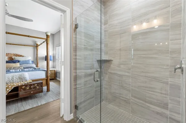 a bathroom with a granite countertop sink a toilet a mirror and bathtub