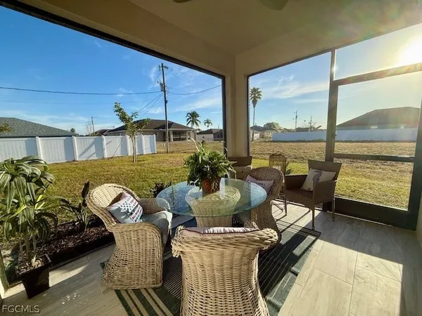 a view of a dining room with furniture and a window