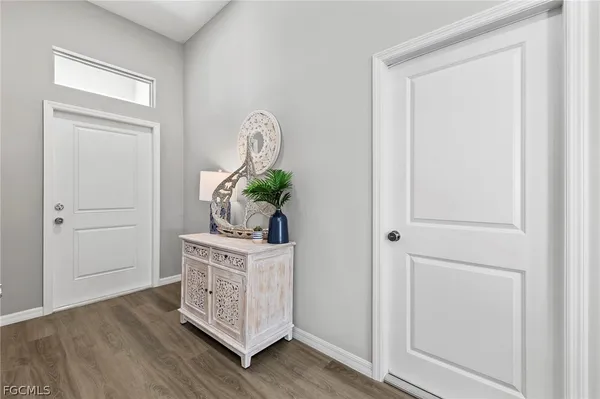 a view of a hallway with front door wooden floor and front door