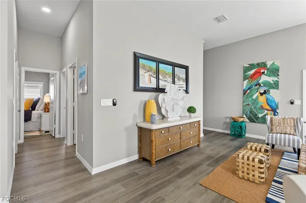 a living room with furniture and a baby crib