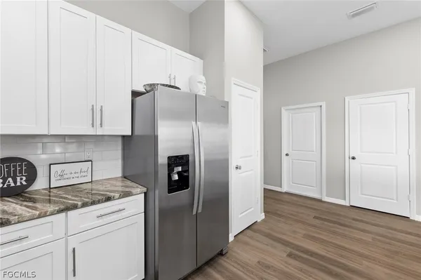 a kitchen with stainless steel appliances granite countertop a refrigerator and a stove top oven