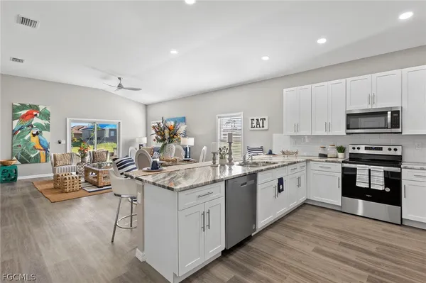 a kitchen with stainless steel appliances granite countertop a stove and cabinets