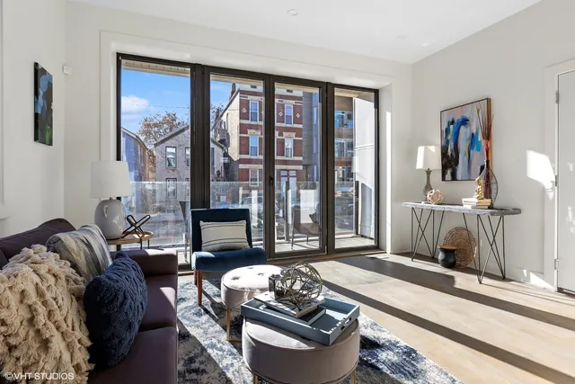 a living room with furniture and a floor to ceiling window