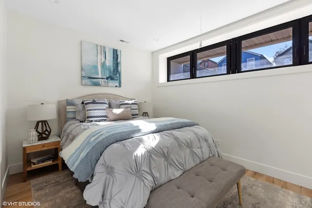 a bedroom with a bed and wall painting