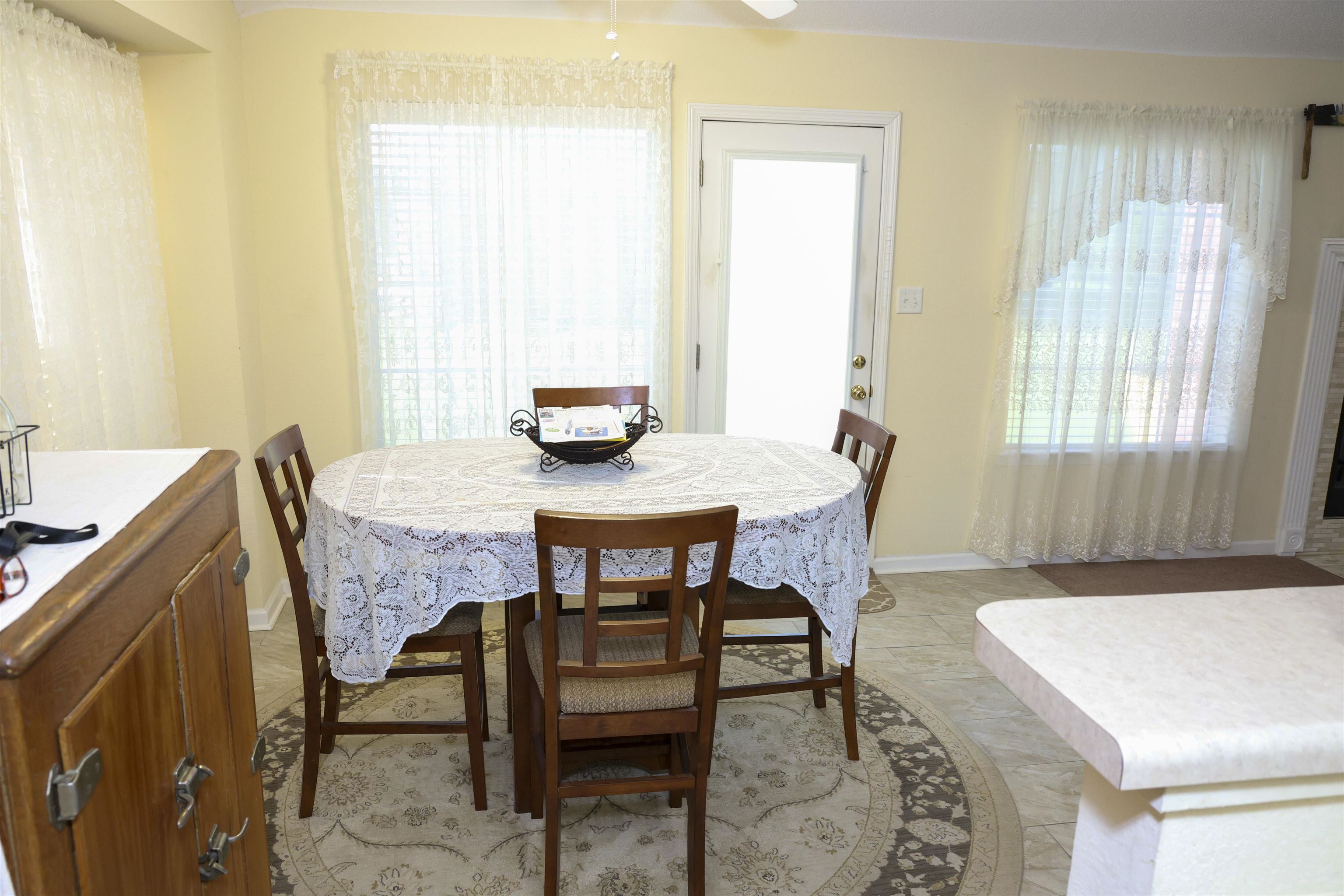 6626 Finch Road Memphis, TN 38141 - Photo 6 of 14 Bright dining area featuring a glass-paned exterior door, multiple windows, and tile flooring