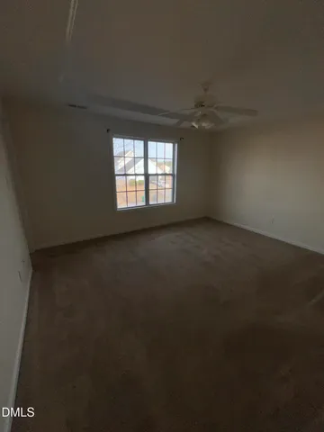 an empty room with mirror and window