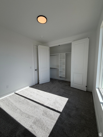 4956 North 925 East, Unit 87 Enoch, UT 84721 - Photo 10 of 19 Room featuring gray carpet, white walls, and a contemporary flush-mount ceiling light