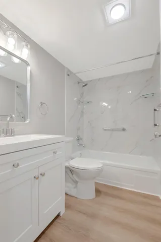 a bathroom with a double vanity sink mirror and a bathtub