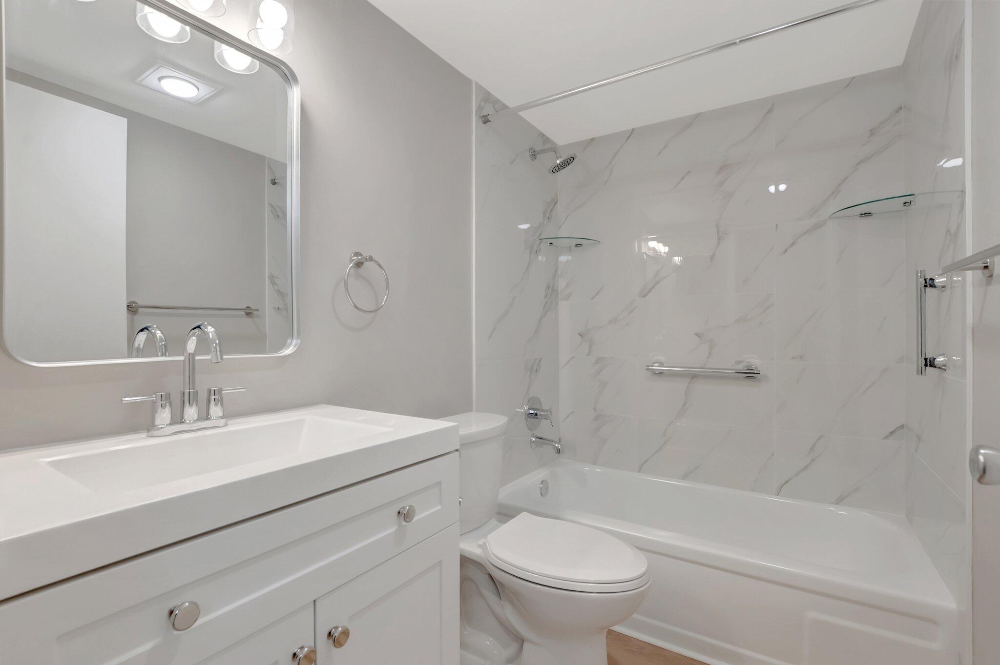 296 Fanshaw H Boca Raton, FL 33434 - Photo 2 of 59 a bathroom with a sink a toilet and a mirror