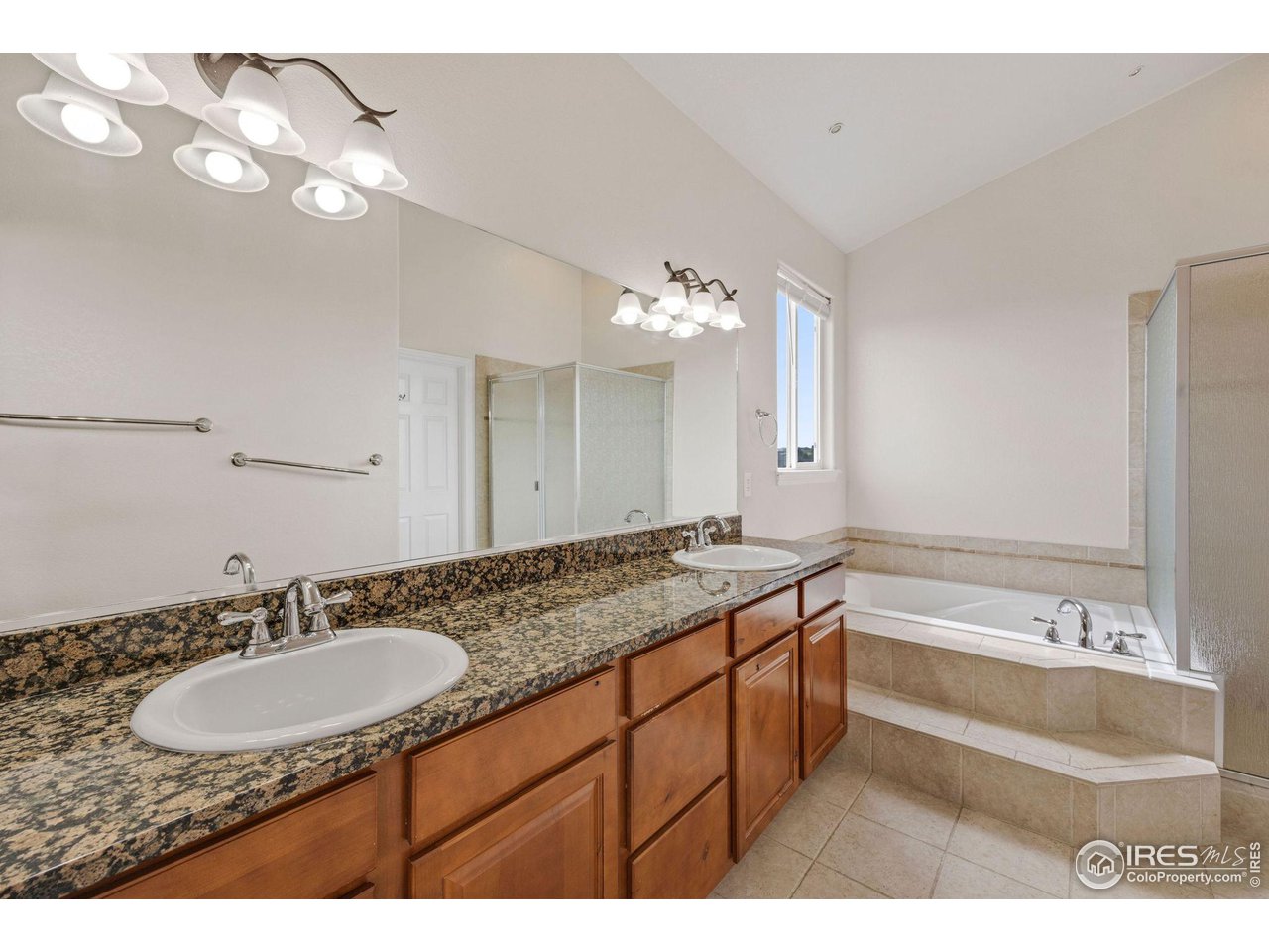 3427 Red Hawk Lane Longmont, CO 80504 - Photo 16 of 33 a bathroom with a sink double vanity granite and a mirror