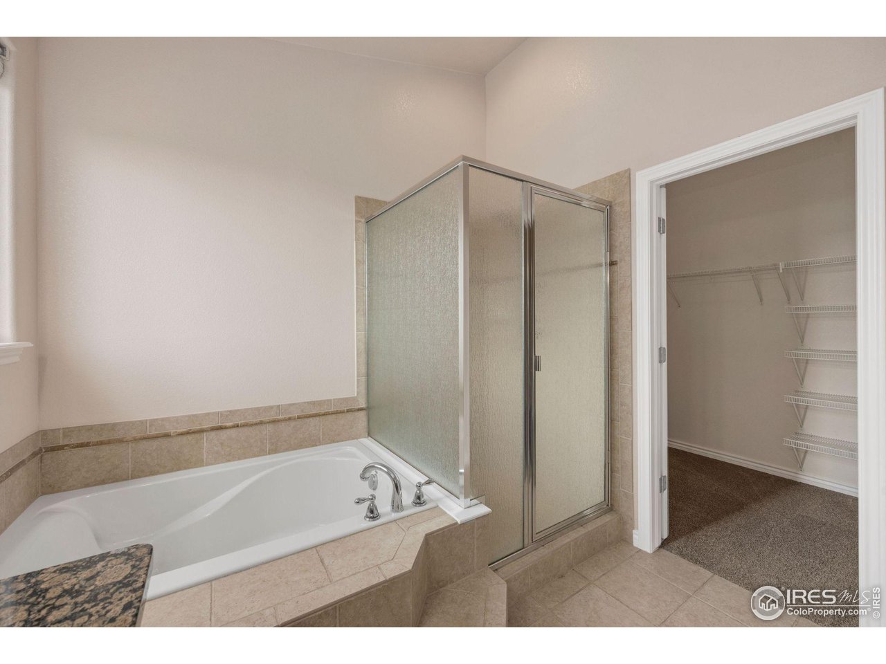 3427 Red Hawk Lane Longmont, CO 80504 - Photo 17 of 33 a bathroom with a tub a sink and a shower