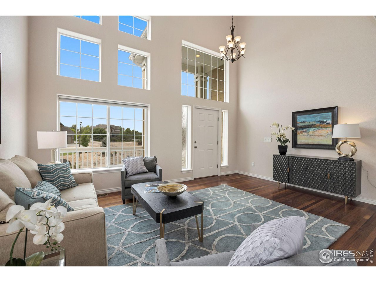 3427 Red Hawk Lane Longmont, CO 80504 - Photo 2 of 33 a living room with furniture and a chandelier
