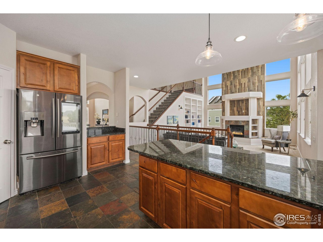 3427 Red Hawk Lane Longmont, CO 80504 - Photo 8 of 33 a kitchen with stainless steel appliances granite countertop a refrigerator a sink and a stove
