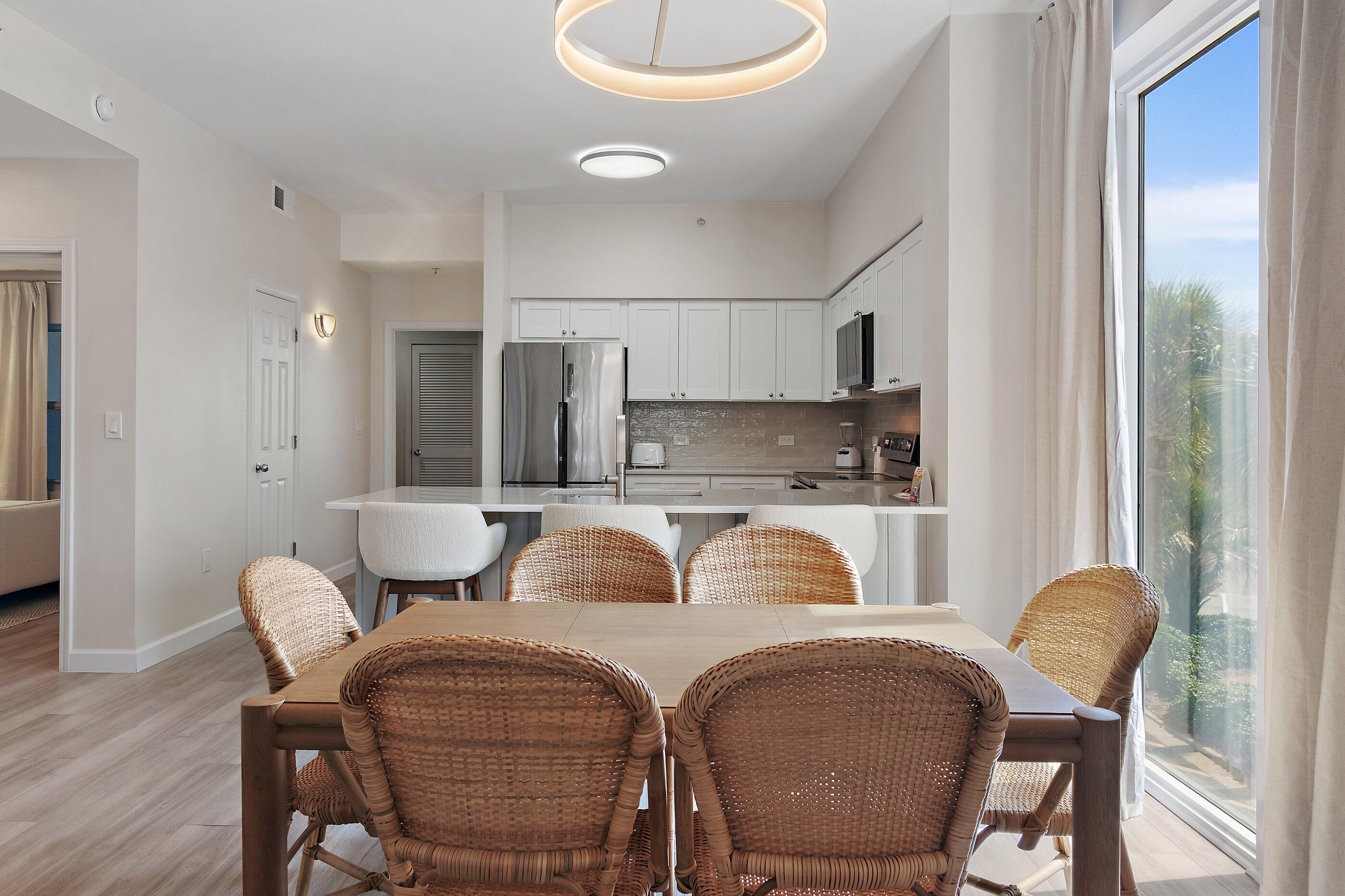 970 Highway 98, Unit 107 Destin, FL 32541 - Photo 11 of 28 a view of a dining room with furniture and wooden floor