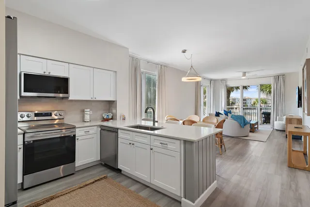 a kitchen with a sink stove and wooden cabinets