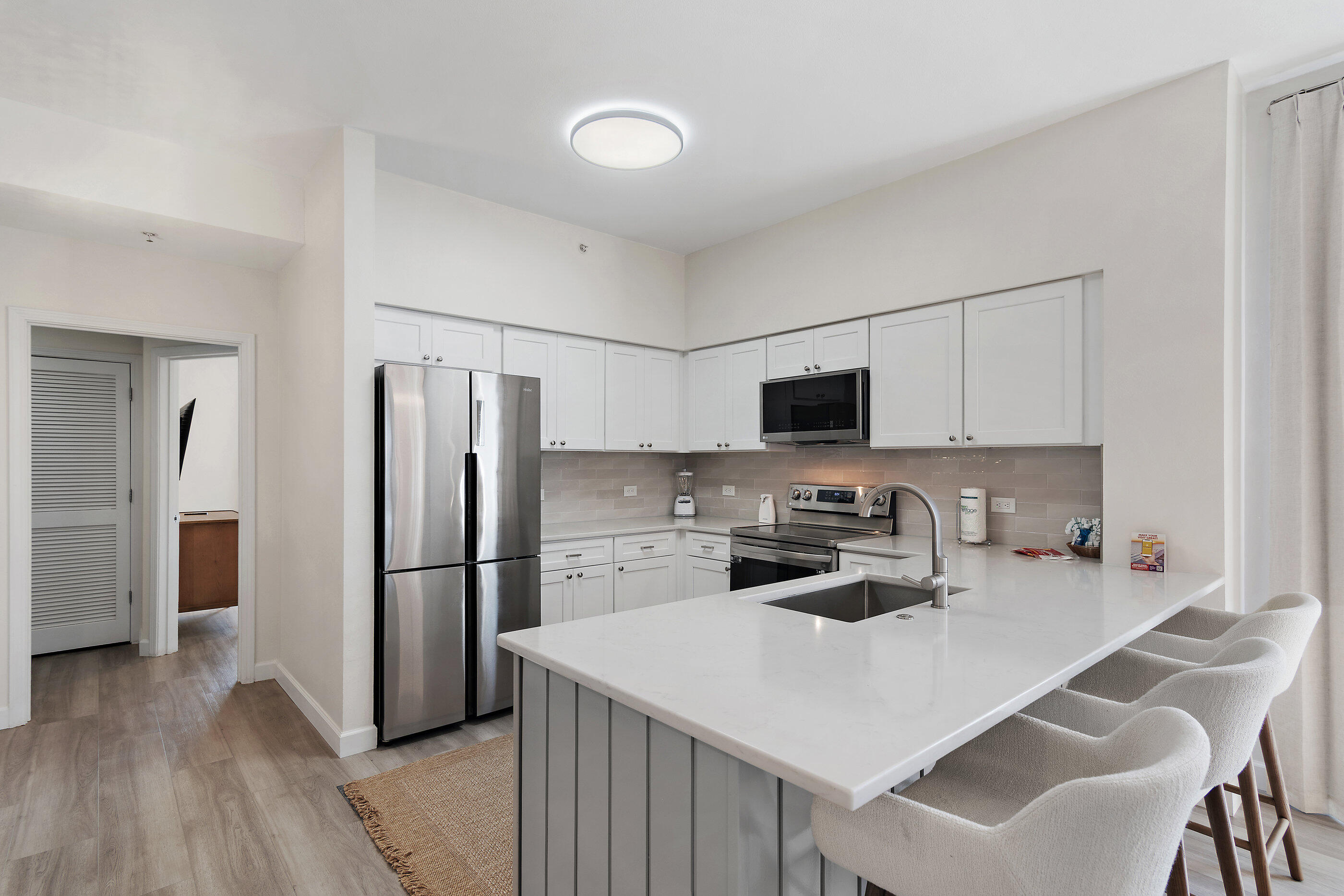 970 Highway 98, Unit 107 Destin, FL 32541 - Photo 13 of 28 a kitchen with stainless steel appliances a refrigerator stove microwave and cabinets