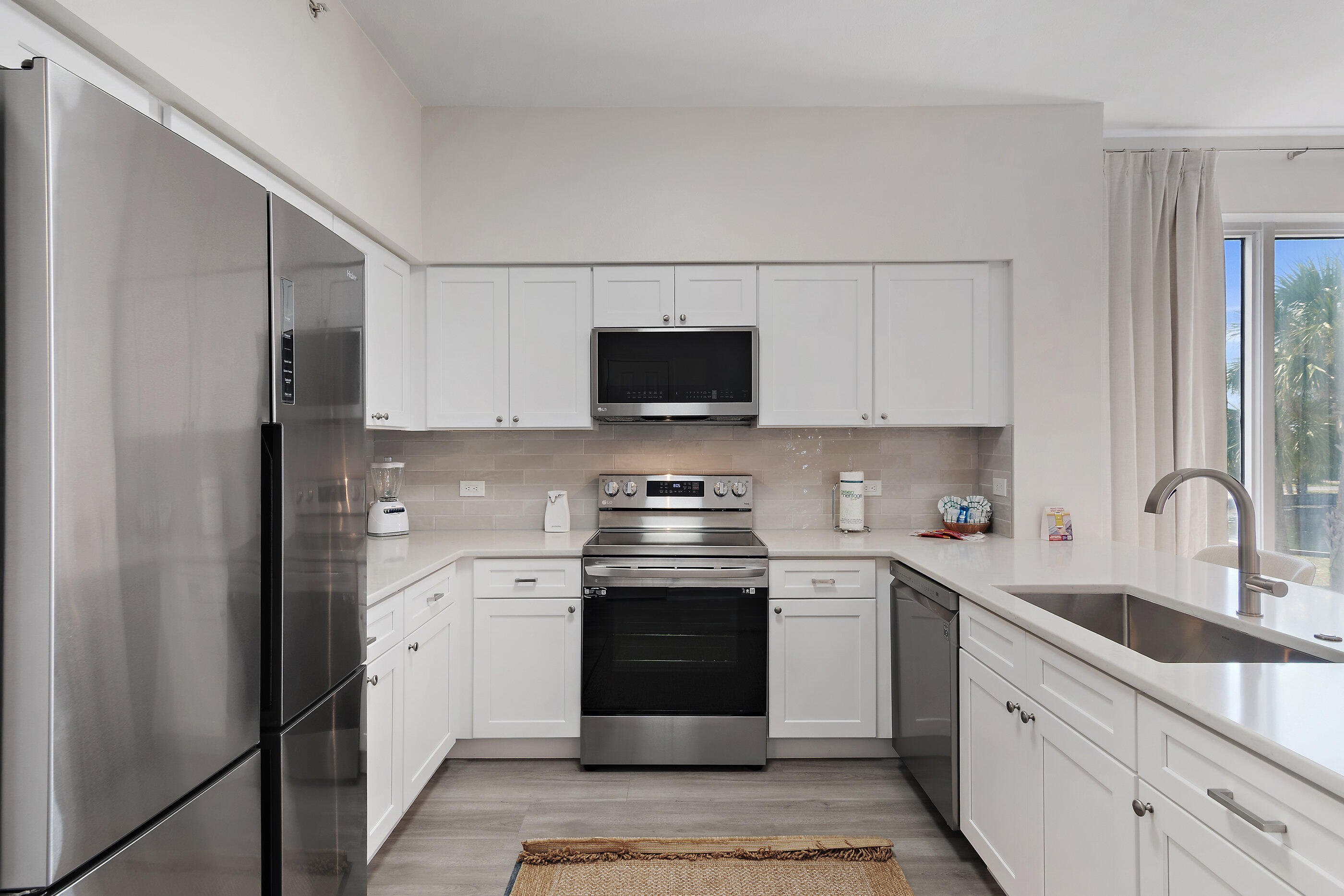 970 Highway 98, Unit 107 Destin, FL 32541 - Photo 14 of 28 a kitchen with stainless steel appliances granite countertop a stove a sink and a refrigerator