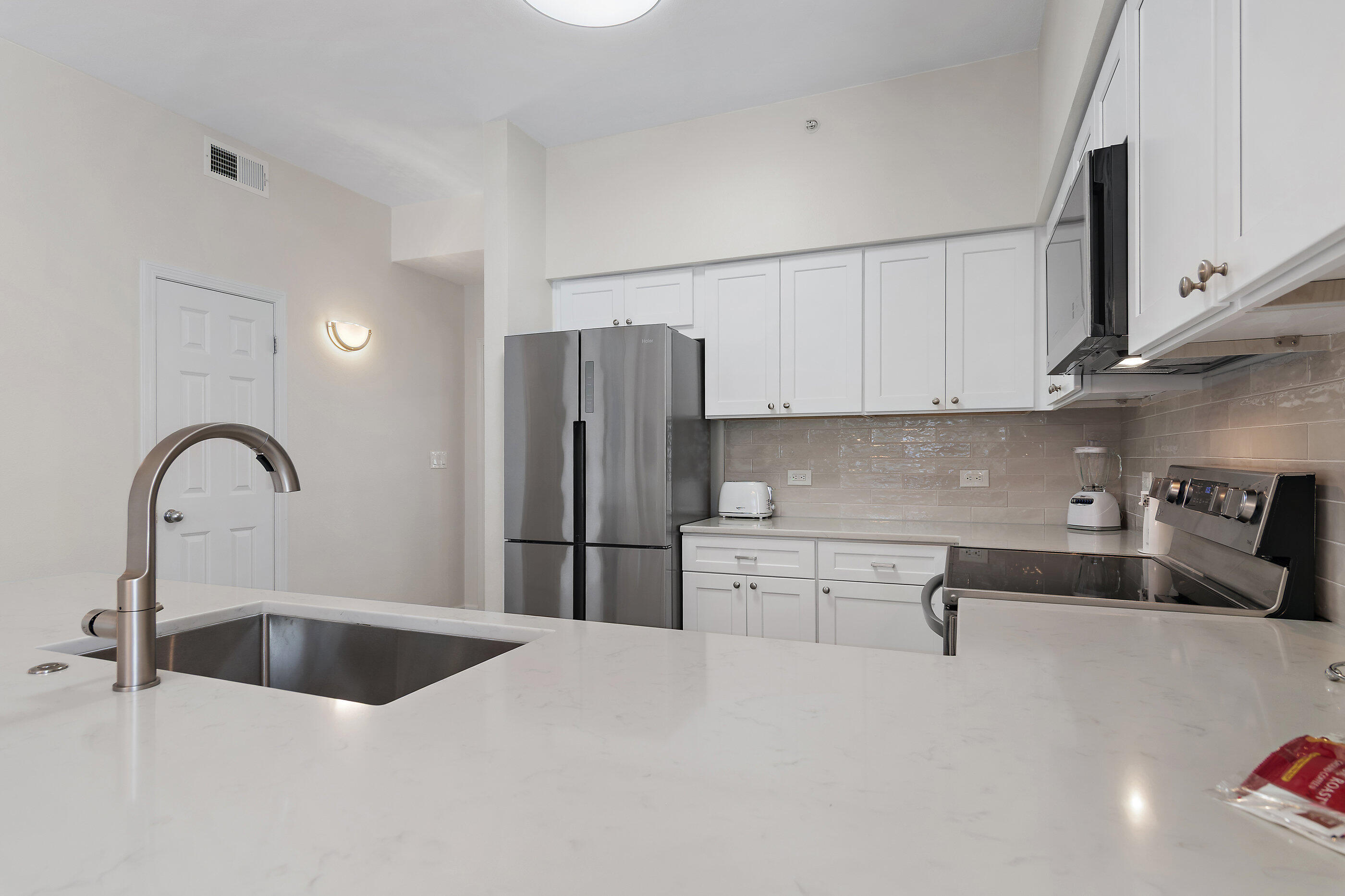 970 Highway 98, Unit 107 Destin, FL 32541 - Photo 15 of 28 a kitchen with stainless steel appliances a sink a stove a refrigerator and cabinets