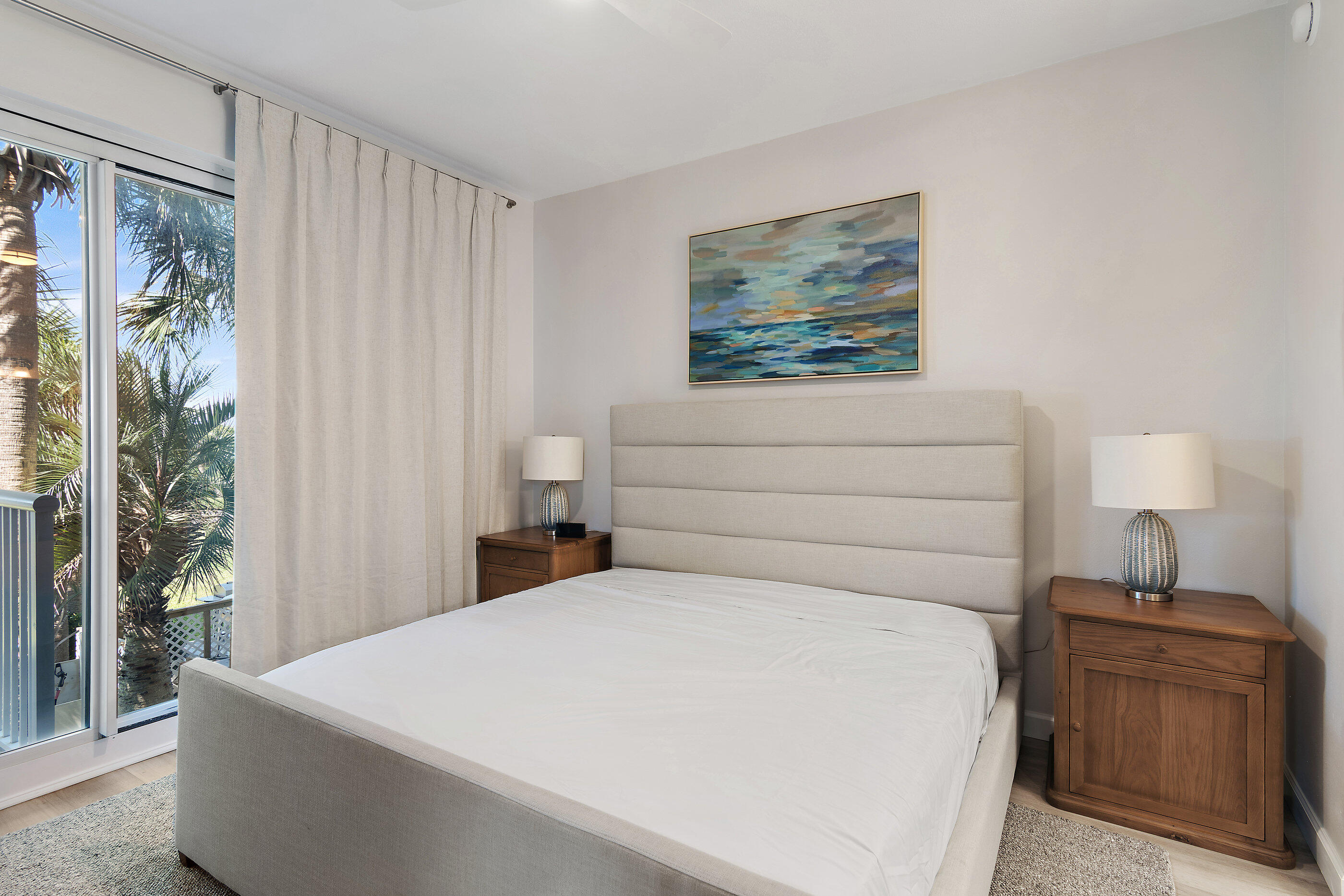 970 Highway 98, Unit 107 Destin, FL 32541 - Photo 16 of 28 a bed room with a bed and a lamp