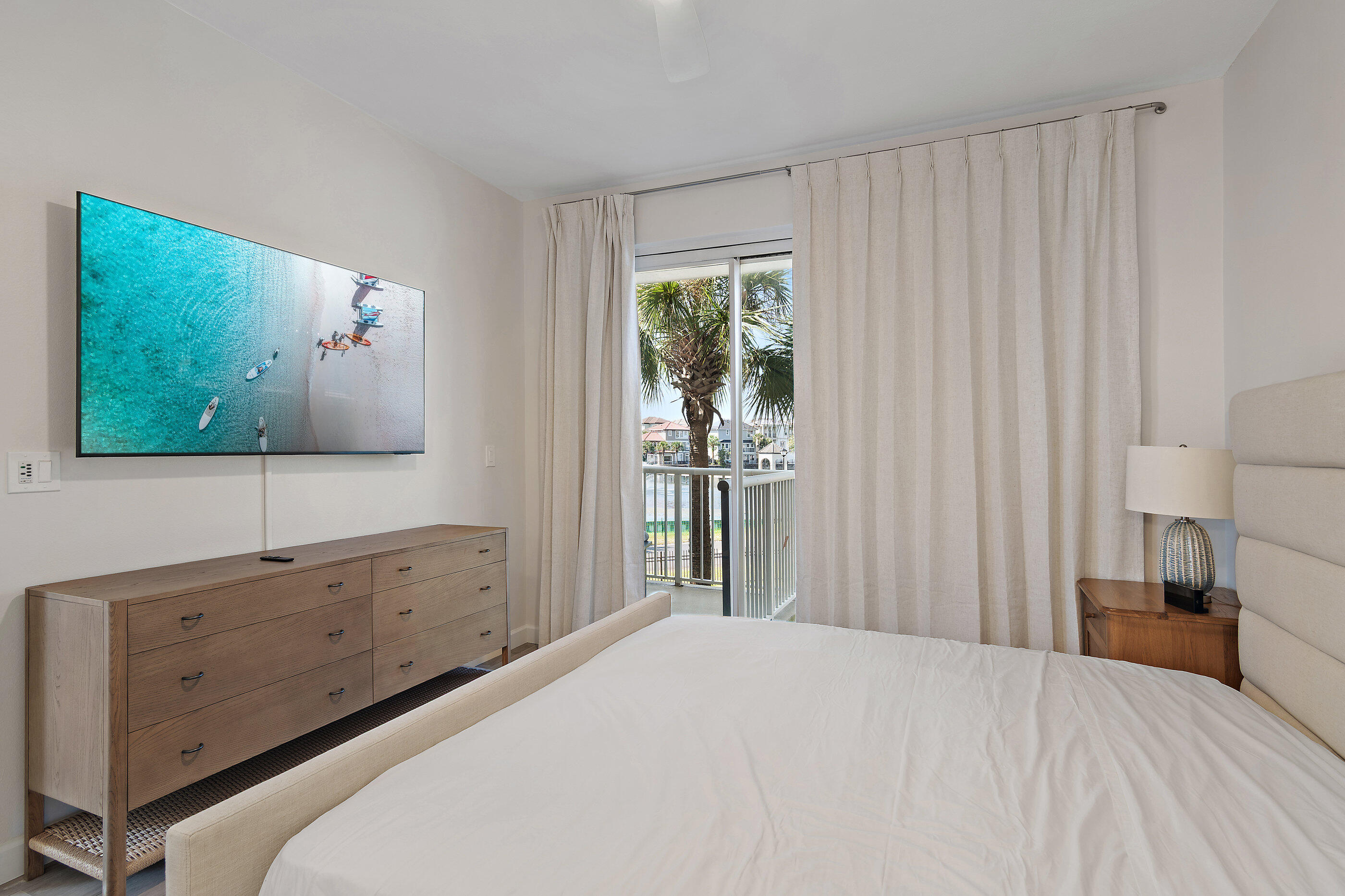 970 Highway 98, Unit 107 Destin, FL 32541 - Photo 17 of 28 a bedroom with a bed and a flat screen tv