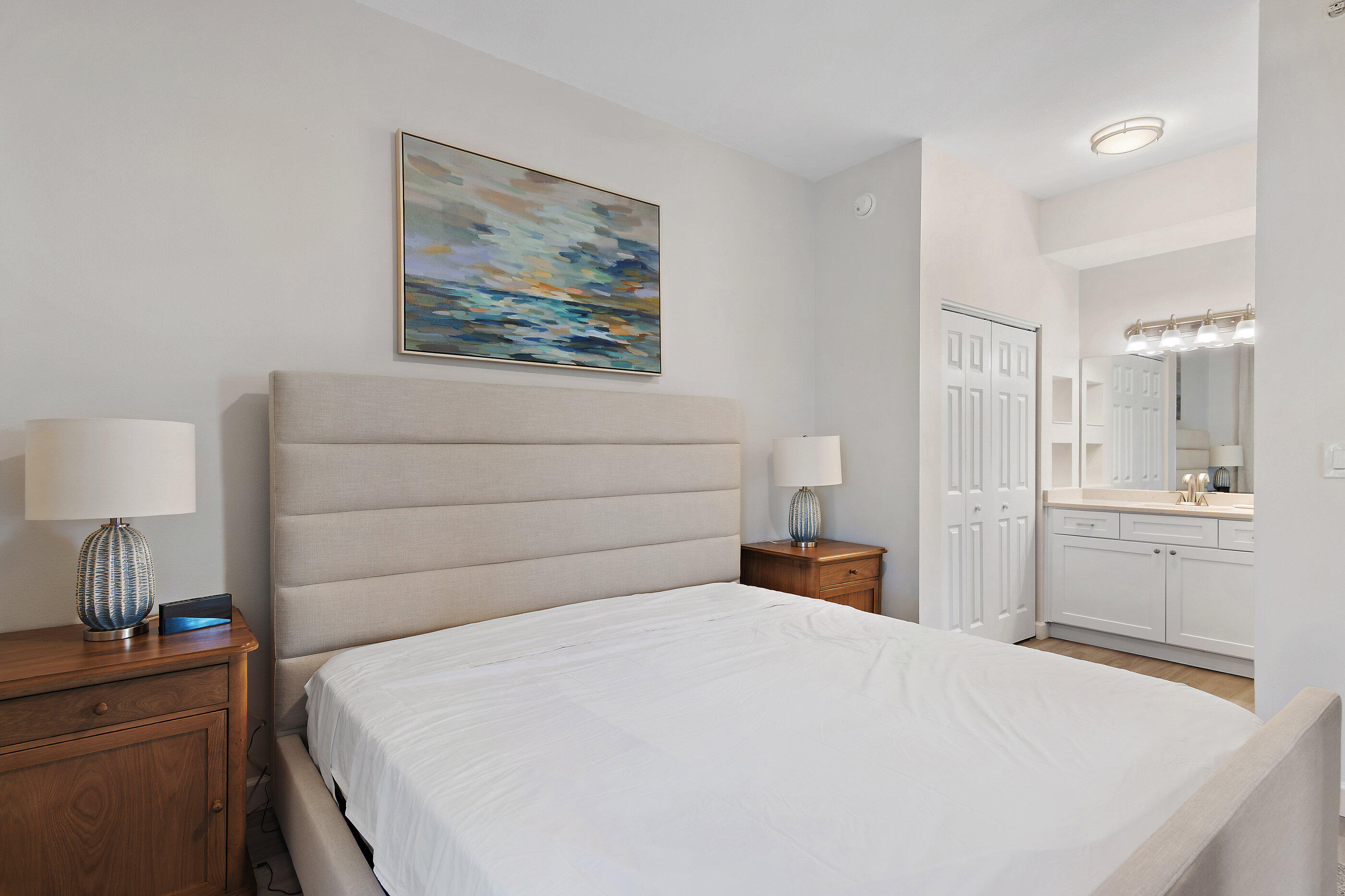 970 Highway 98, Unit 107 Destin, FL 32541 - Photo 18 of 28 a bedroom with a bed and a chandelier