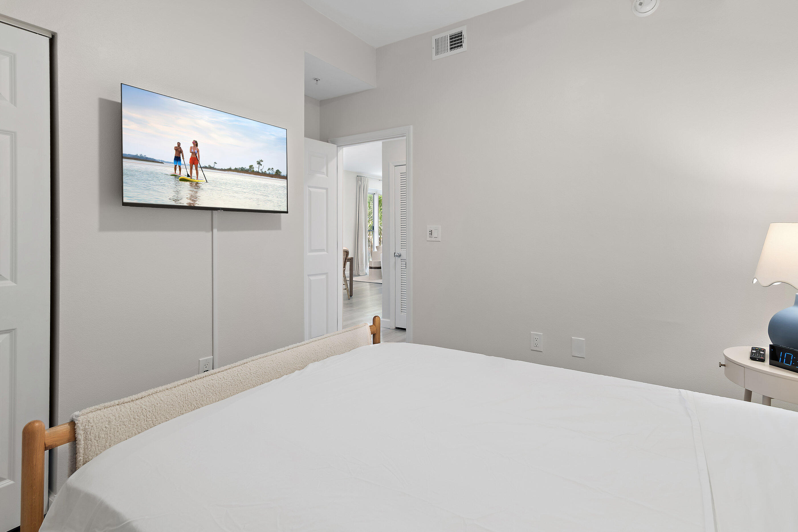 970 Highway 98, Unit 107 Destin, FL 32541 - Photo 21 of 28 a bedroom with a bed and a painting on the wall
