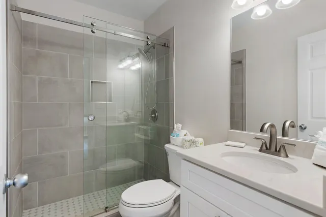 a bathroom with a sink a toilet and shower