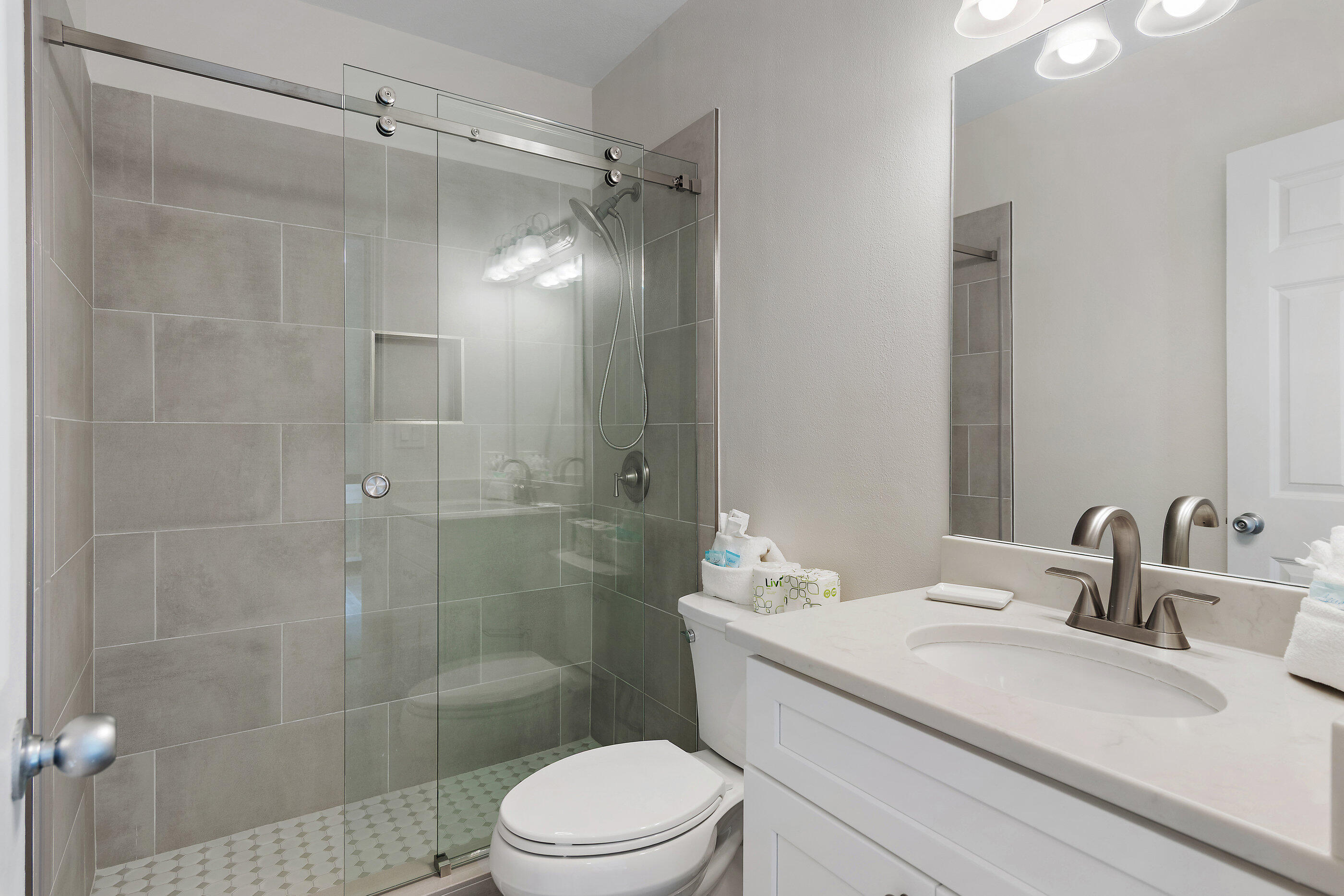 970 Highway 98, Unit 107 Destin, FL 32541 - Photo 25 of 28 a bathroom with a sink a toilet and shower