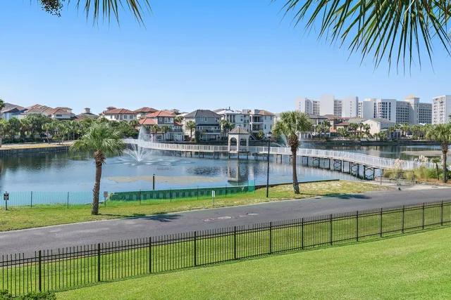 a view of swimming pool with outdoor seating and lake view