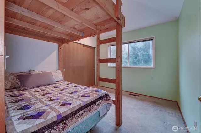 a bathroom with a granite countertop sink a toilet and a mirror