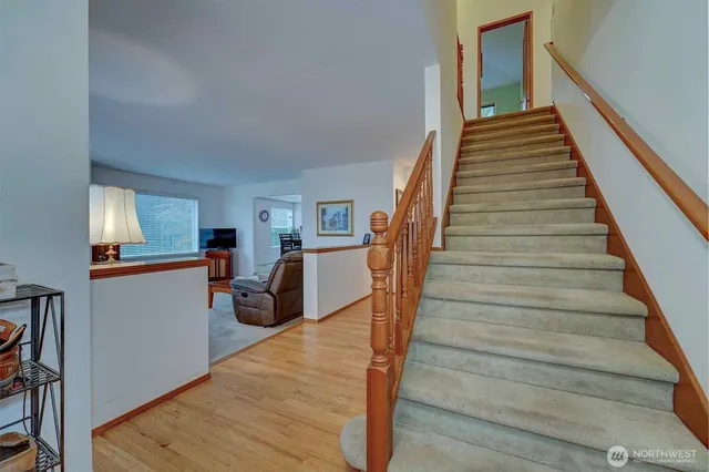 a view of entryway and hall with wooden floor