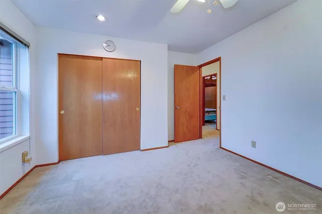 a bedroom with a bed dresser and a window