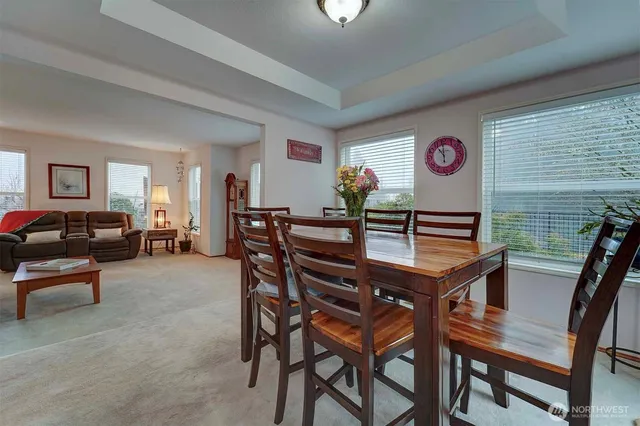 a view of a dining room with furniture and chandelier