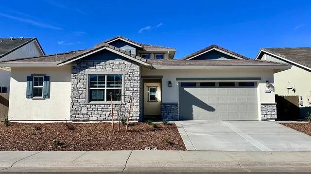 a front view of a house with garage and window