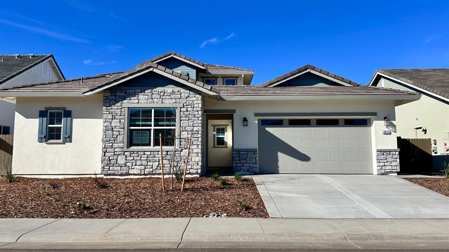 a front view of a house with garage and window