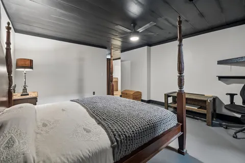 a bedroom with a bed a table and chairs
