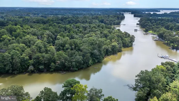 an aerial view of residential house with outdoor space and lake view