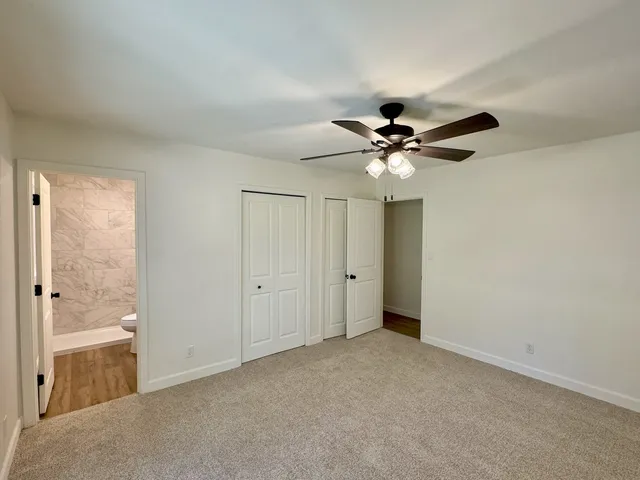a view of an empty room with a ceiling fan